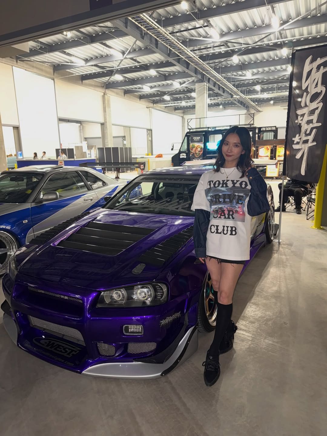 A model posing with a car at the event